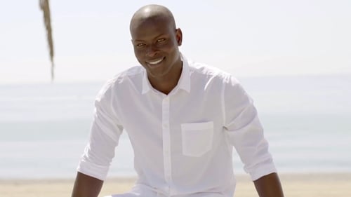 Good Looking Black Model Seated Near Sandy Beach