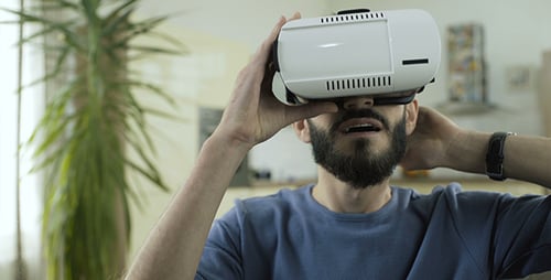 Man Using Virtual Reality Headset in Home
