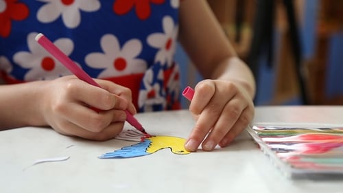 Child Creates Colorful Art Project at Home