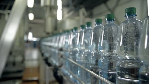 Water Bottles Moving Along a Conveyor Belt