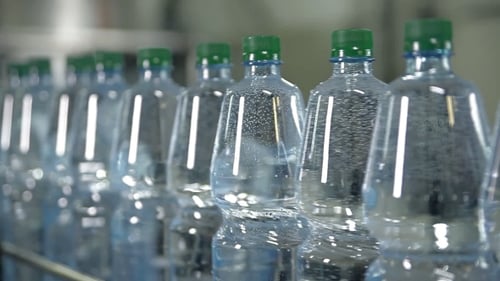 Water Bottles Moving on Conveyor Belt in Factory