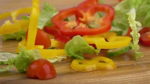 Slices of Ripe Vegetables are Falling on the Table