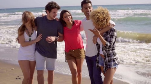 Group of Friends Laughing on Beach Vacation
