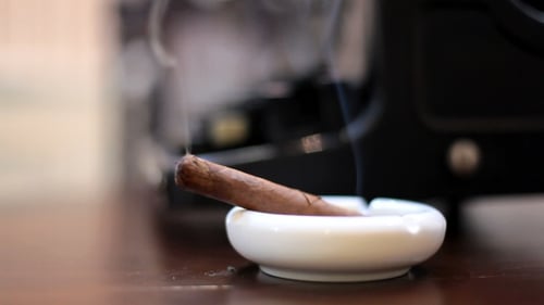 Man Smoking Cuban Cigar In Bar