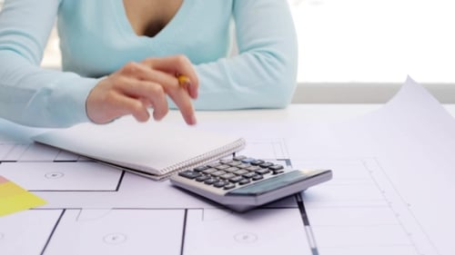 Woman With Blueprint Counting On Calculator 53