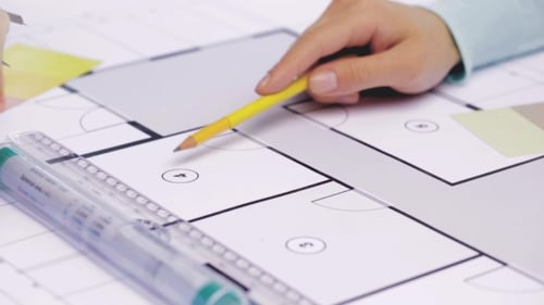 Architects Reviewing Blueprints with Pencil and Ruler