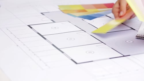 Woman With Blueprint And Swatches Choosing Color 121