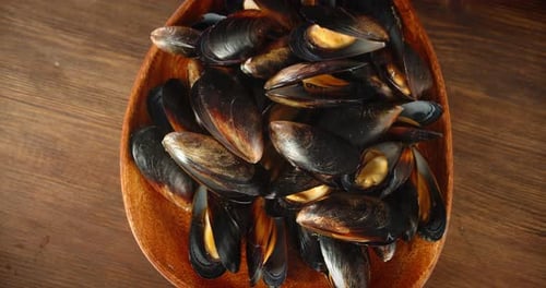 Delicious Mussels in Wooden Bowl Close Up