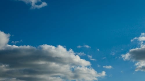 Clouds Drifting Peacefully Across Bright Blue Sky