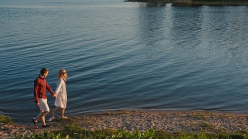Yong Couple Walking On The Beach