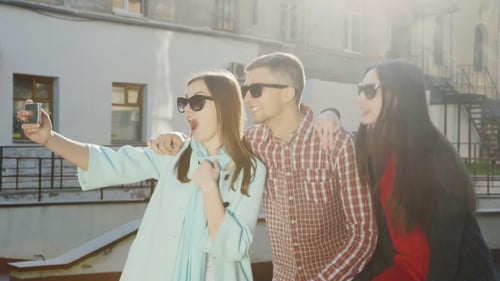 Group Of Young Friends - One Man And Two Women Doing Selfie