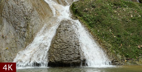 Picturesque Waterfall Flowing Over Rocky Terrain