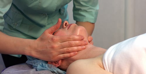Woman Receiving Rejuvenating Facial Massage at Spa