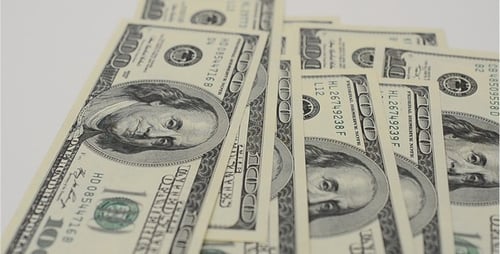 Counting One Hundred Dollar Bills on White Surface