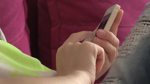 Hand Holding and Scrolling on Mobile Phone