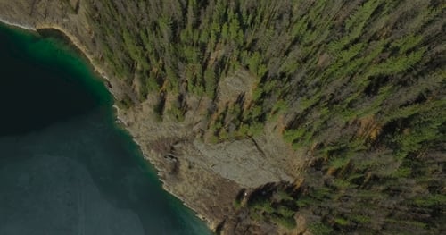 Aerial Of Flying Over Trees To Mountain Lake