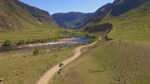 Car On a Winding Road In The Mountains