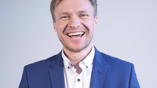 Man in Blazer Smiling Broadly at the Camera