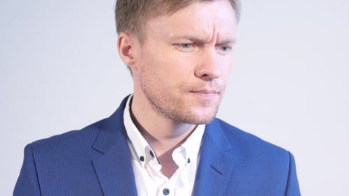 Adult Man in Blue Jacket Looks Intently