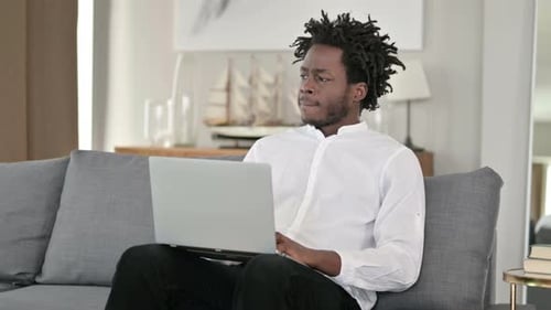 Young Adult Working on Laptop at Home
