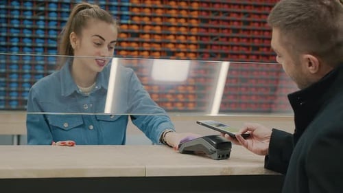Man Paying With Phone in Retail Store