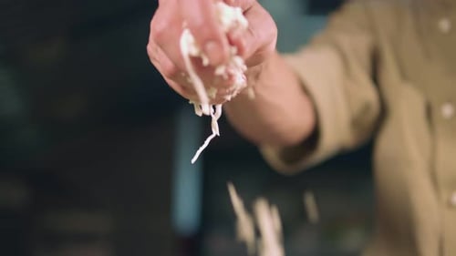 Hand Squeezing Shredded Cheese or Cabbage