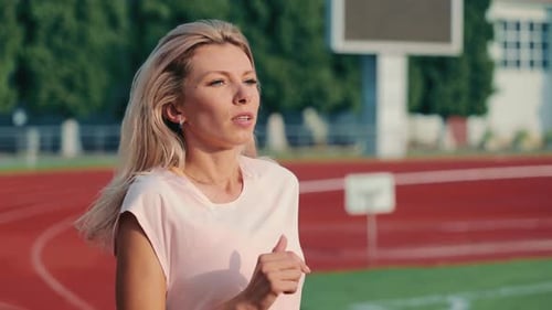 Woman Running on Track for Health and Fitness