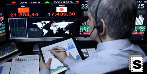 Financial Analyst Working at Desk With Stock Data