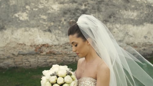 Elegant Bride Smelling Wedding Bouquet Outdoors