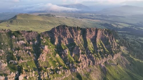 Dolomites mountains peaks with a hiking path on a summer sunrise