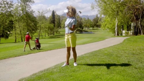 Woman Golfer on Scenic Green Golf Course
