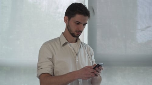 Young Adult Using Smartphone Indoors