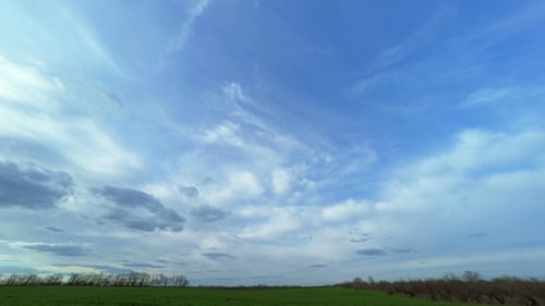 Cloudy Sky over the Green Field