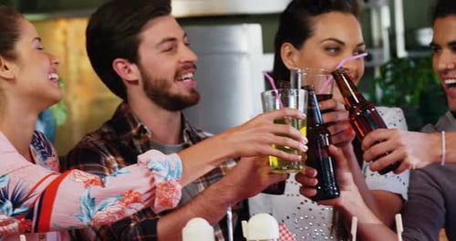 Friends toasting drinks together in restaurant