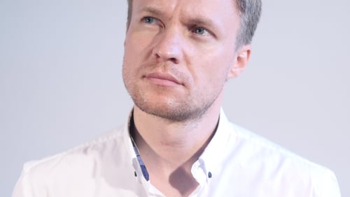 Contemplative Man Looks Away in Close Up Shot