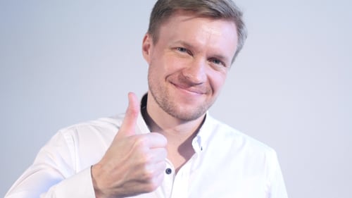 Smiling Man Gives Thumbs Up Gesture