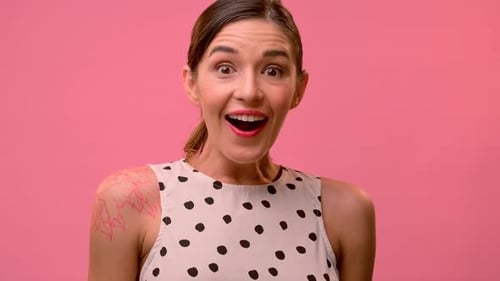 Woman Smiling, Polka Dot Top on Pink Background