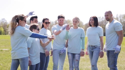 Group Of Volunteers Putting Hands On Top In Park 11
