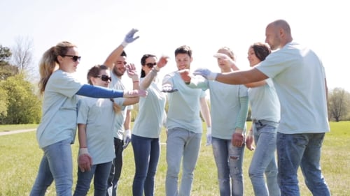 Group Of Volunteers Putting Hands On Top In Park 12