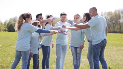 Group Of Volunteers Putting Hands On Top In Park 10