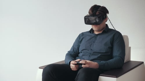 Man Plays Video Games with VR Headset Indoors