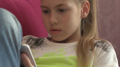 Child Focused on Tablet Device Indoors