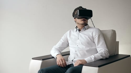 Young Handsome Caucasian Man On Sofa Wearing VR Headset Glasses