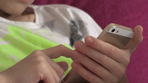Child Using Cell Phone in Close Up Shot