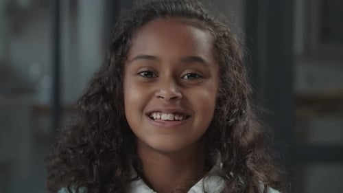 Young Girl Smiling and Blowing a Kiss