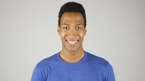Smiling Young Adult in Blue Shirt Portrait