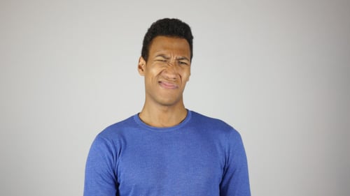 Young Adult Expressing Disgust in Studio Setting