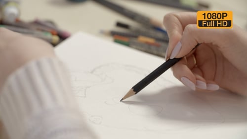 Artist Hand Drawing Sketch with Pencil Close Up