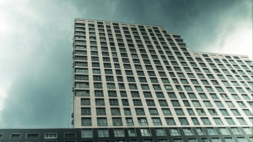 Apartment House And Clouds . Rising And Declining Real Estate Concept