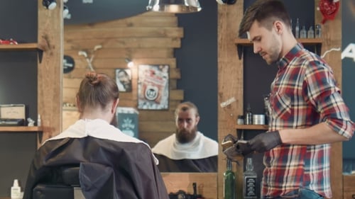 Barber Prepares at Station in Warmly Lit Shop